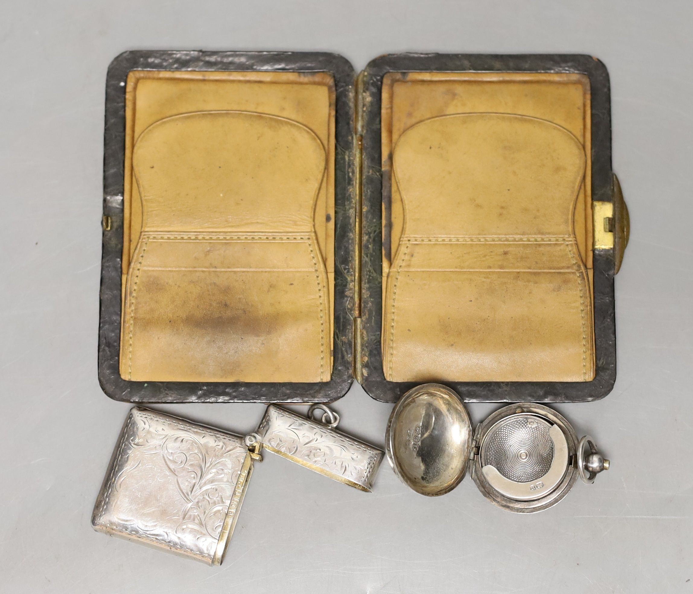 A late Victorian engraved silver sovereign case, a silver vesta case and an Edwardian 9ct gold mounted leather card purse.